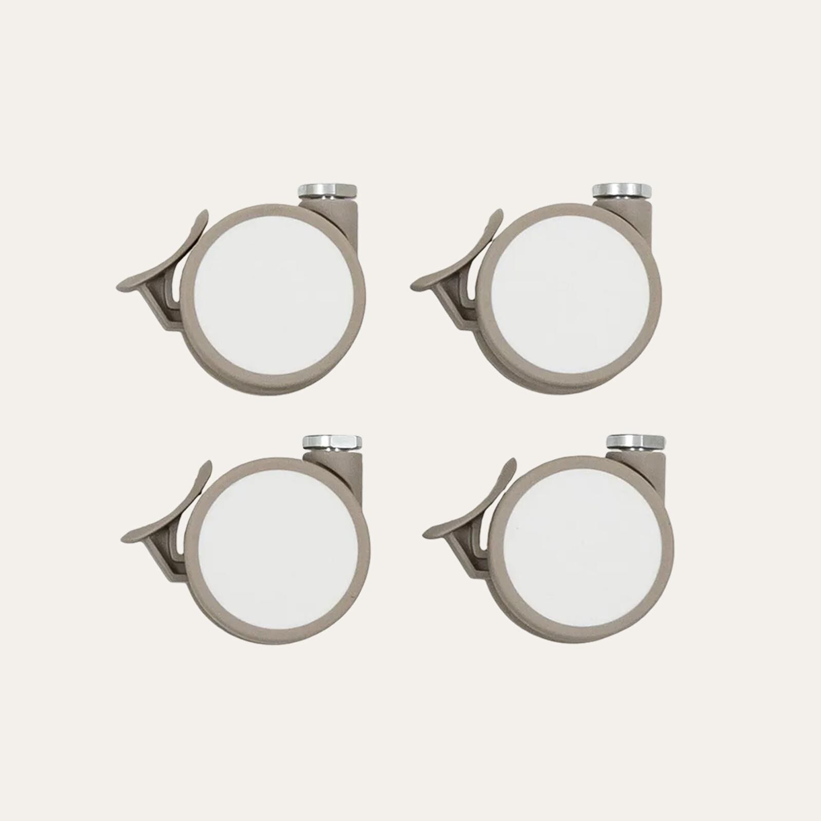Four grey casters with white wheels on a light background.