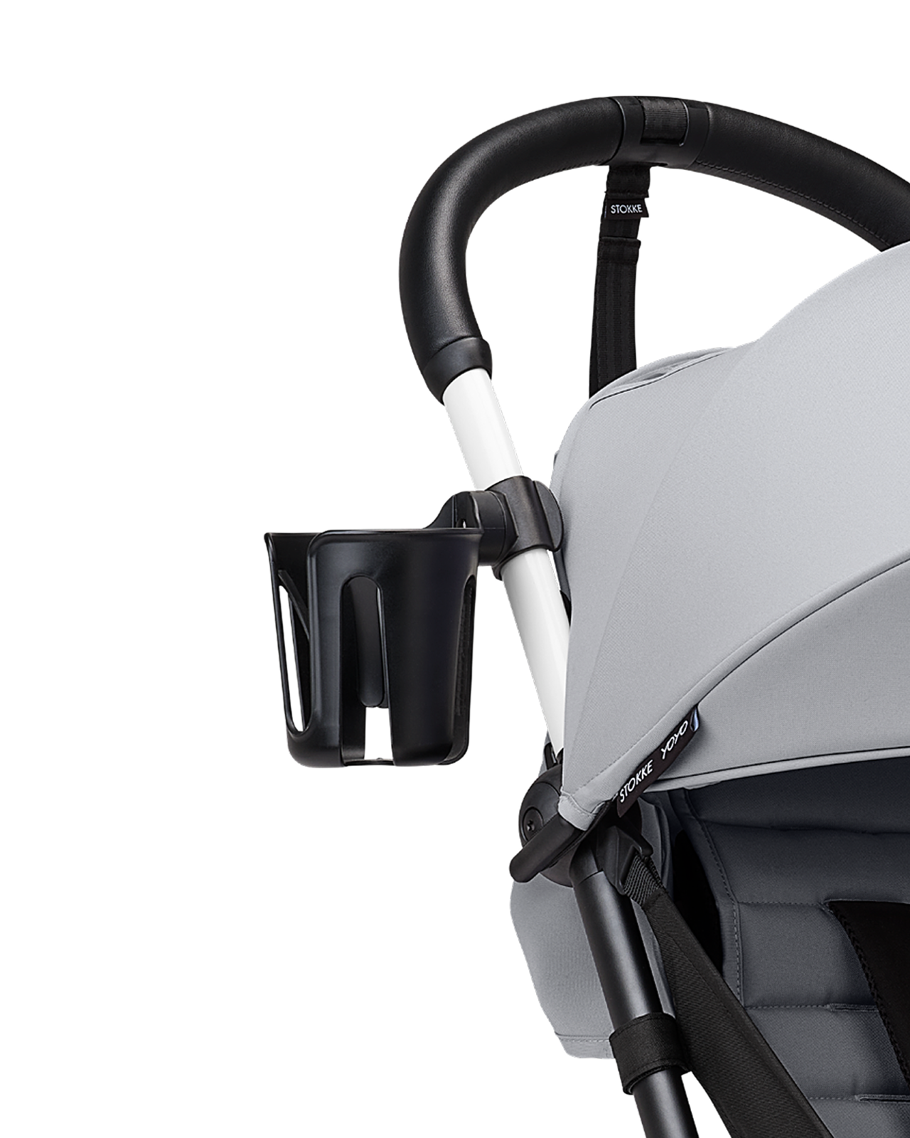 Close-up of a STOKKE YOYO stroller with a black cup holder attached to the handlebar.