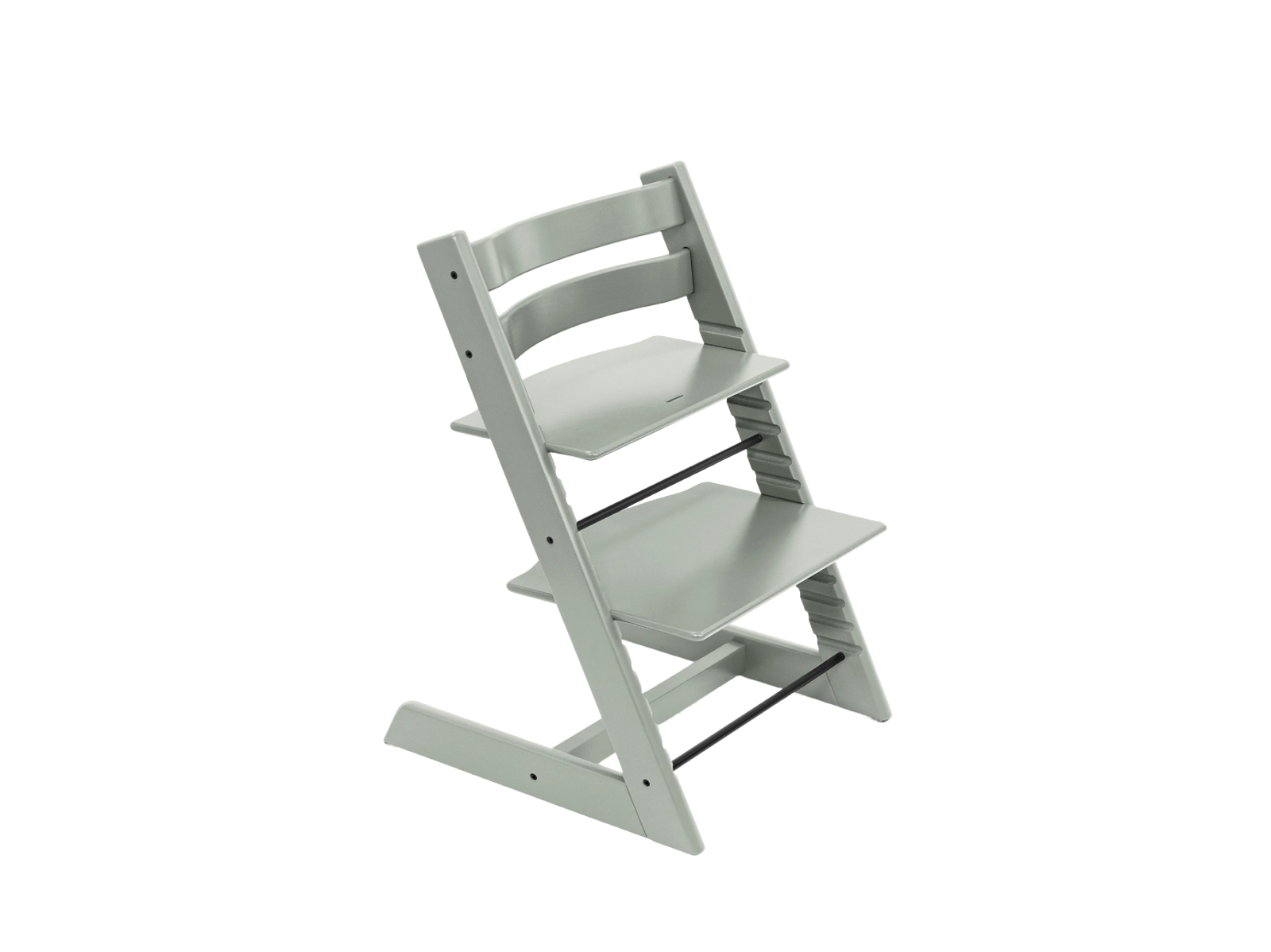Light gray Tripp Trapp chair on a black background.