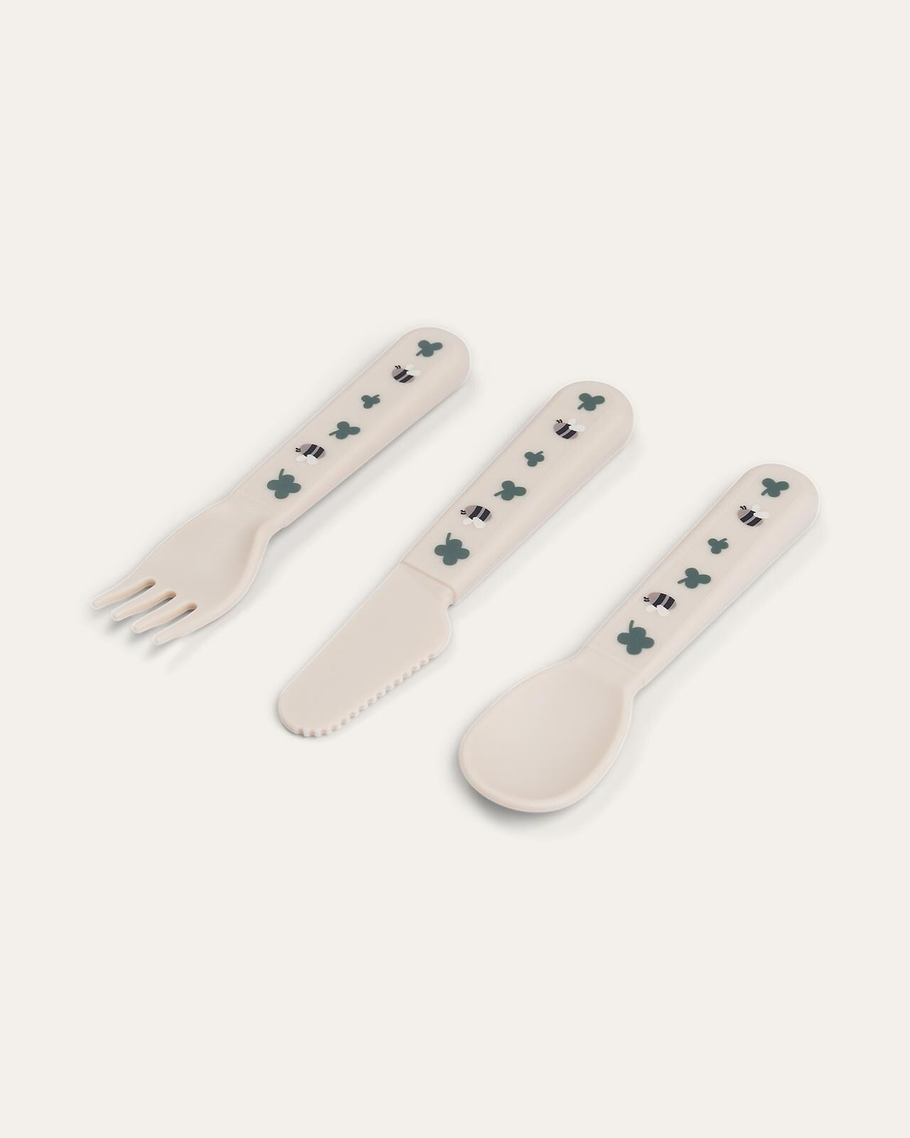 Foodie bestekset Crèmekleurige kinderbestekset met vork, mes en lepel met bijen- en klaverpatronen.