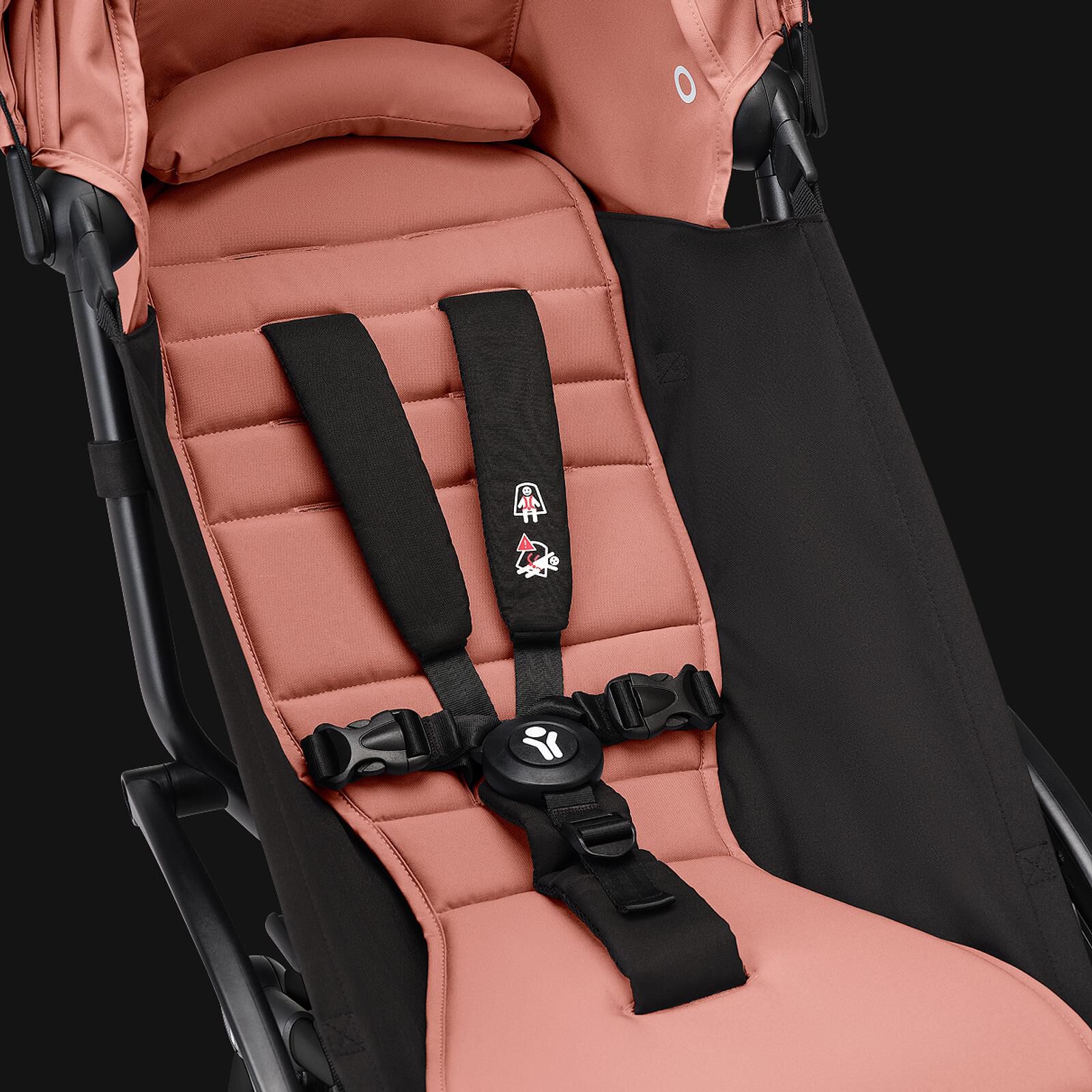 Närbild av en STOKKE YOYO barnvagnsits i ingefära, med svart sele.