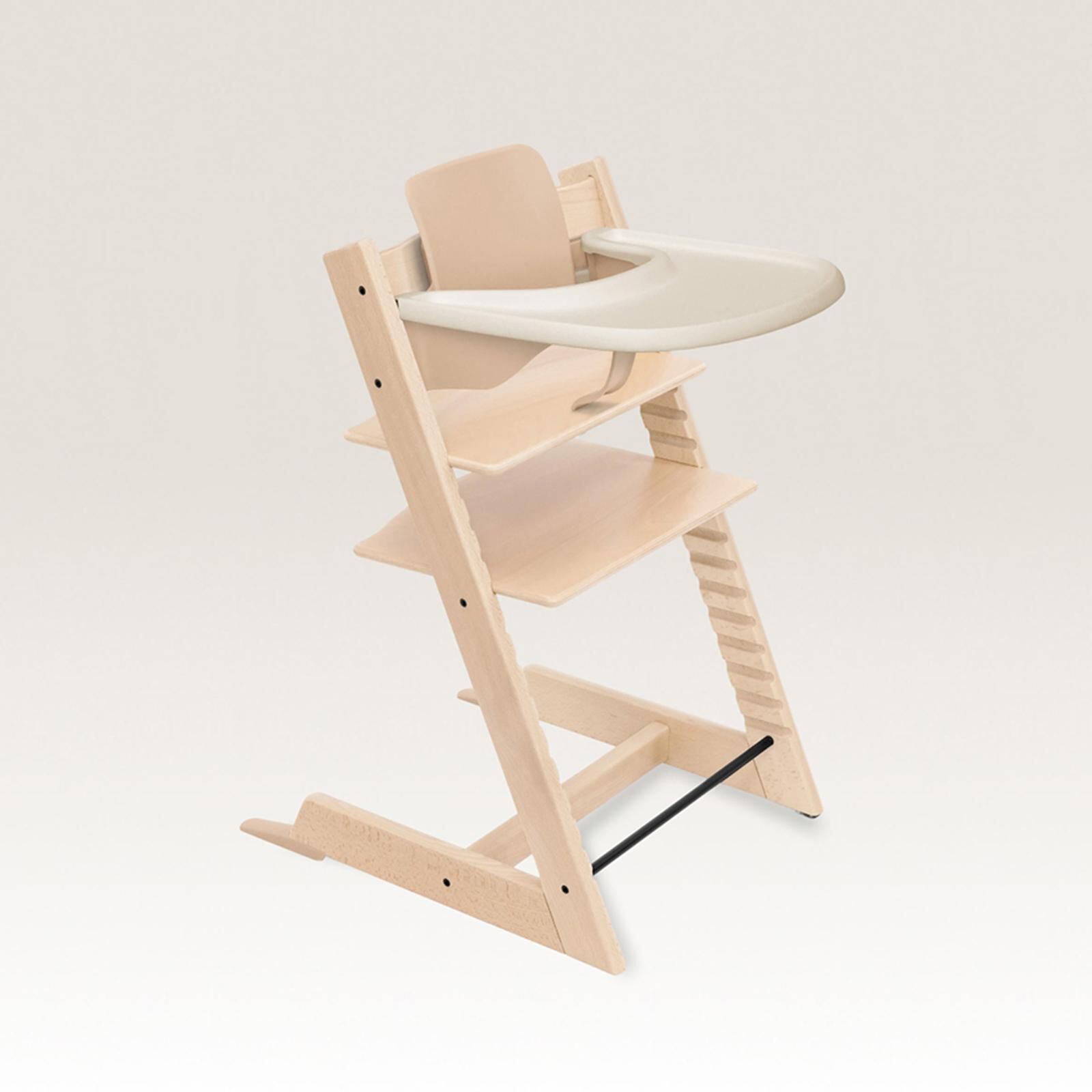 Natural wood Tripp Trapp high chair with beige Baby Set and white tray.