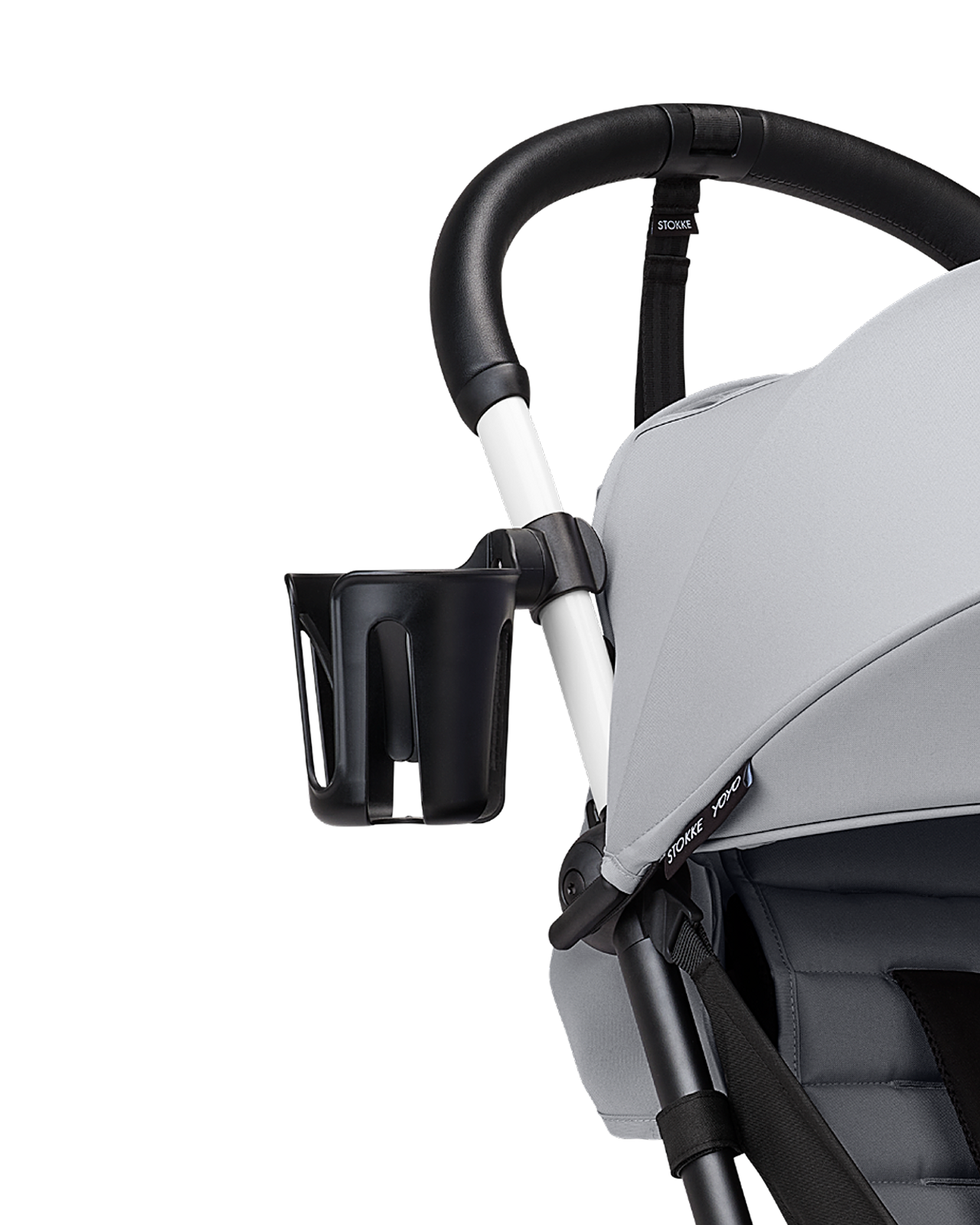 Close-up of a STOKKE YOYO stroller with a black cup holder attached to the handlebar.