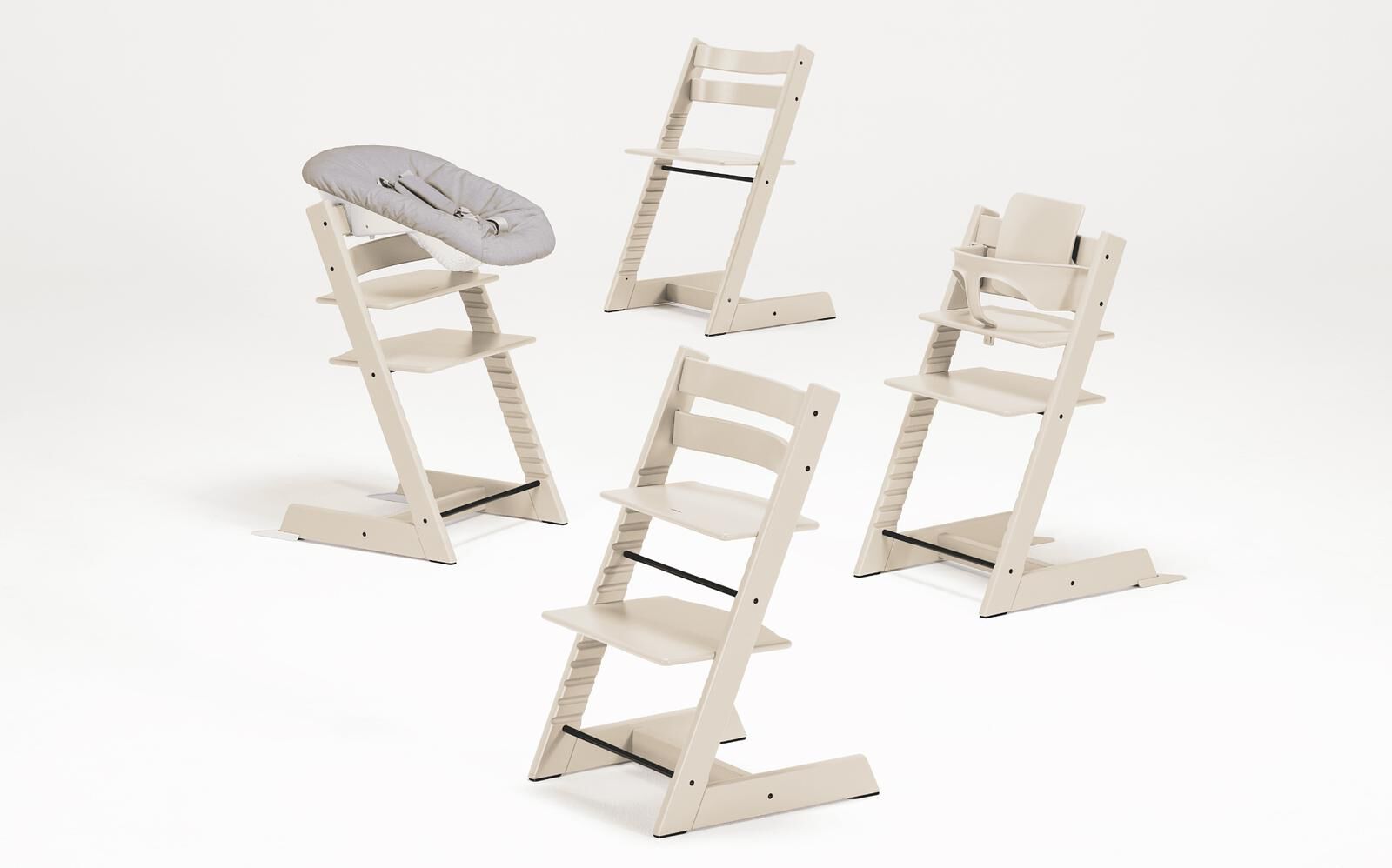 Four Tripp Trapp chairs: two standard, one high chair with Newborn Set, one high chair with Baby Set.