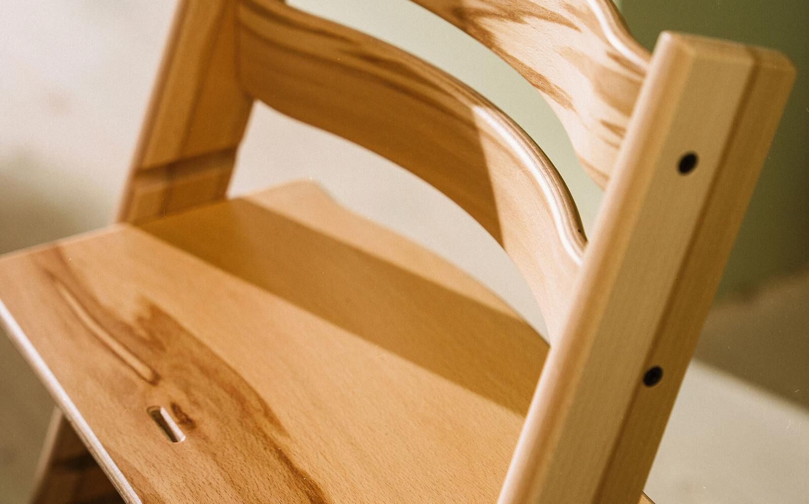 Close-up of a natural wood Tripp Trapp chair.