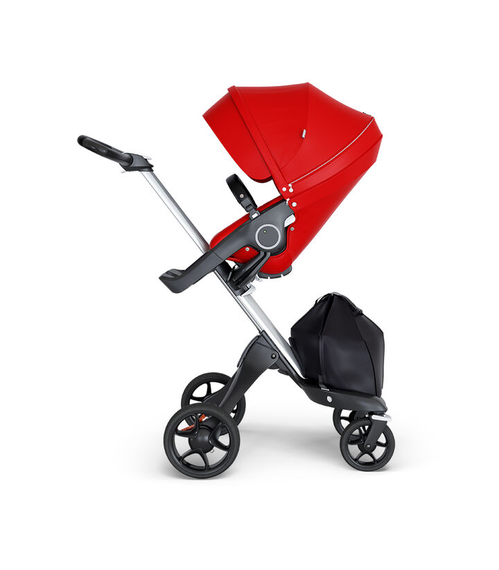 Stokke® Xplory® wtih Silver Chassis and Leatherette Black handle. Stokke® Stroller Seat Red. view 1