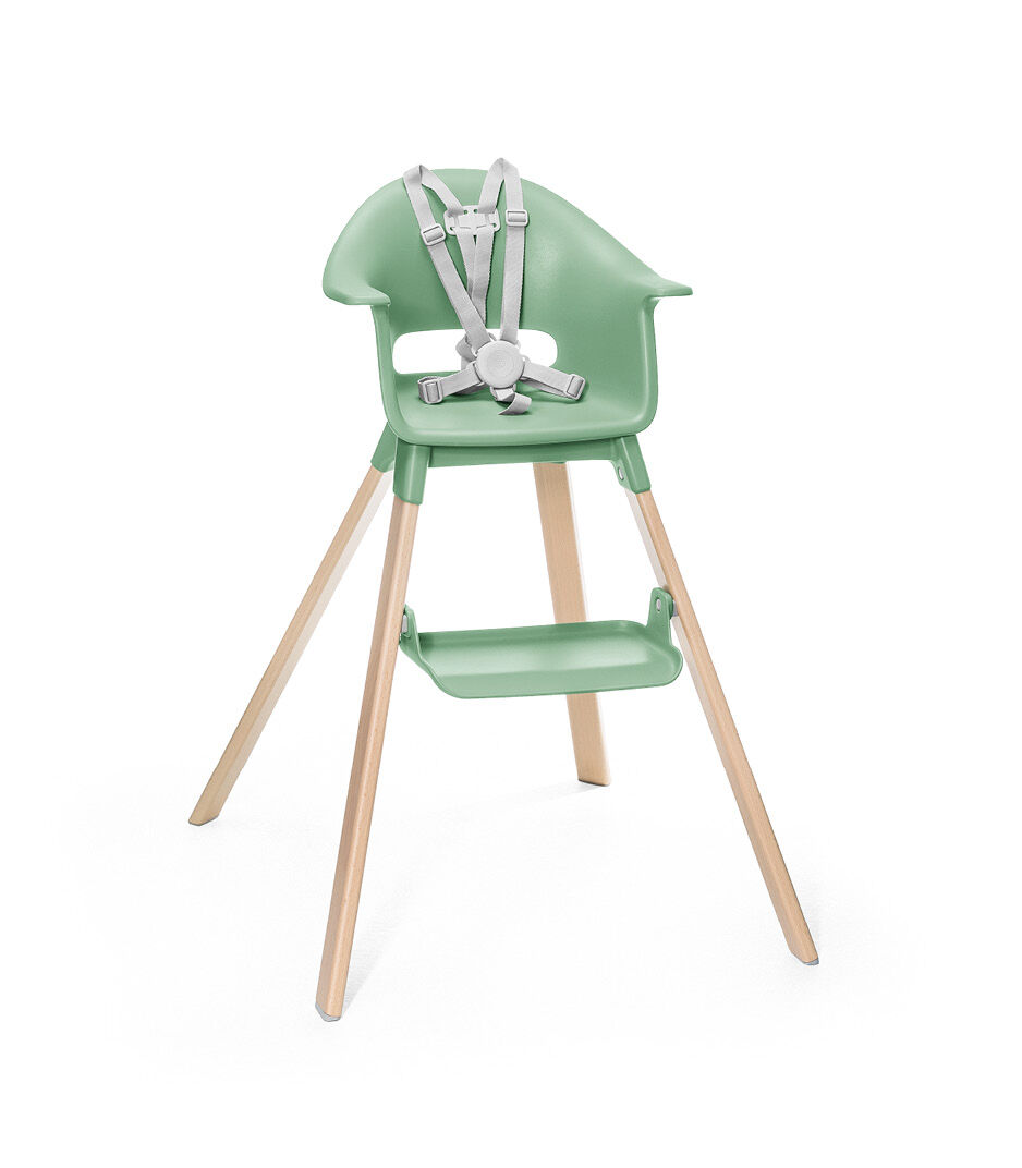 Stokke® Clikk™ High Chair. Natural Beech wood and Clover Green plastic parts. Stokke® Harness attached. Footrest high.