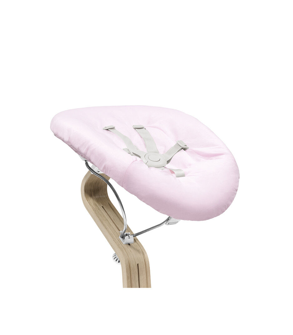 Stokke® Nomi® Chair Natural-White with Newborn Set Pink. Close-up.