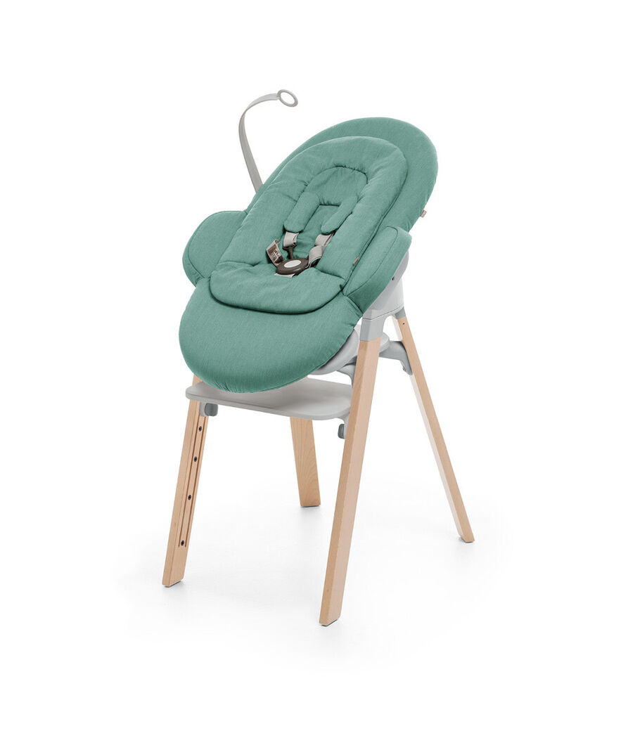 Stokke&reg; Steps&trade; Natural and Light Grey plastic with Stokke&reg; Steps Bouncer in Cool Jade.