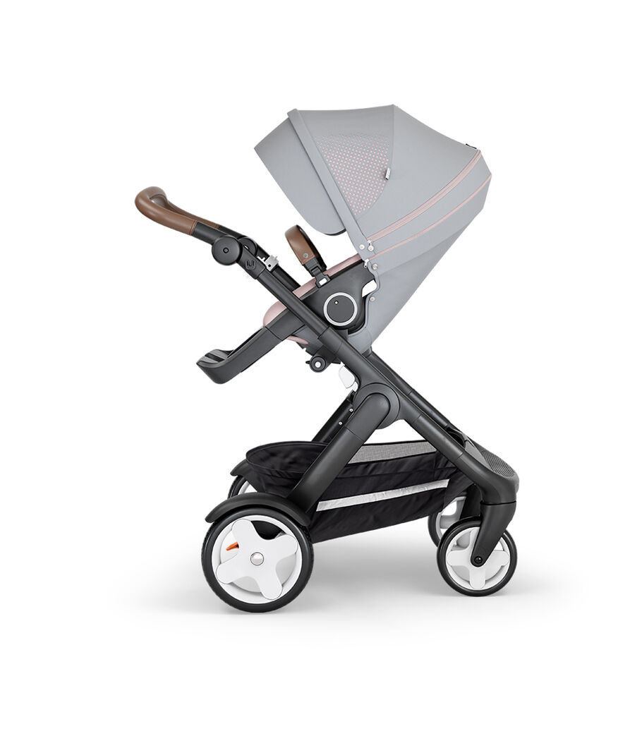 Stokke® Trailz™ with Black Chassis, Brown Leatherette and Classic Wheels. Stokke® Stroller Seat, Athleisure Pink. view 10