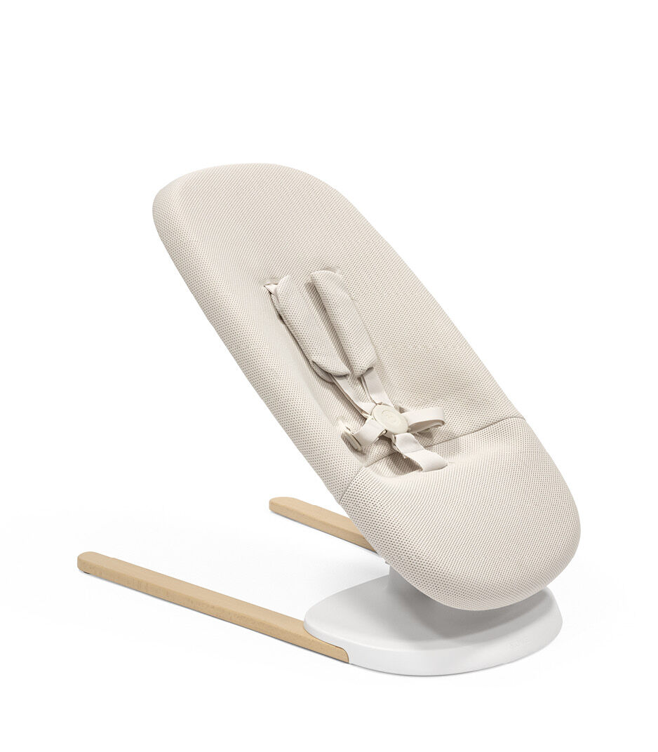 Stokke® Yoga™ Bouncer Light Sand. Middle position without inlay. Angled view. galery image 11