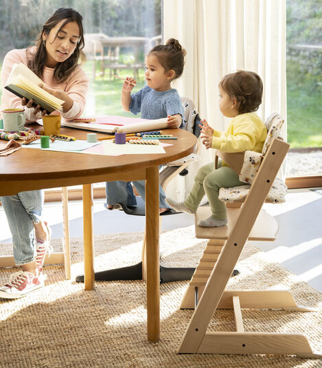 Tripp Trapp® High Chair Natural w/Disney Mickey Celebration Cushion. Stokke® Nomi® Natural/Black w/Disney Signature Cushion. view 6