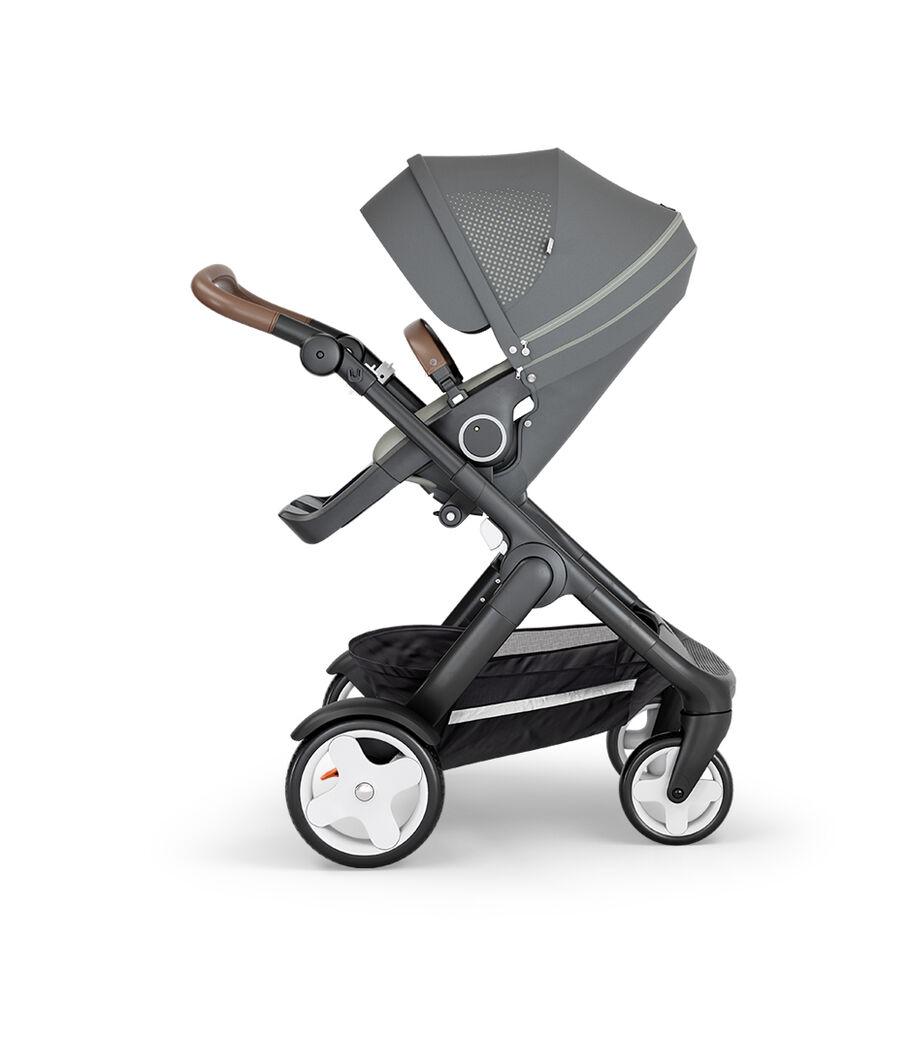 Stokke® Trailz™ with Black Chassis, Brown Leatherette and Classic Wheels. Stokke® Stroller Seat, Athleisure Green. view 11