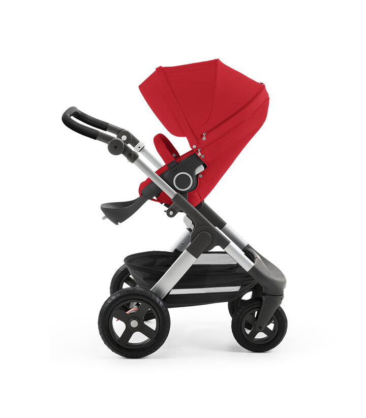 Stokke® Trailz™ with silver chassis and Stokke® Stroller Seat, Red. Leatherette Handle. Terrain Wheels. view 1