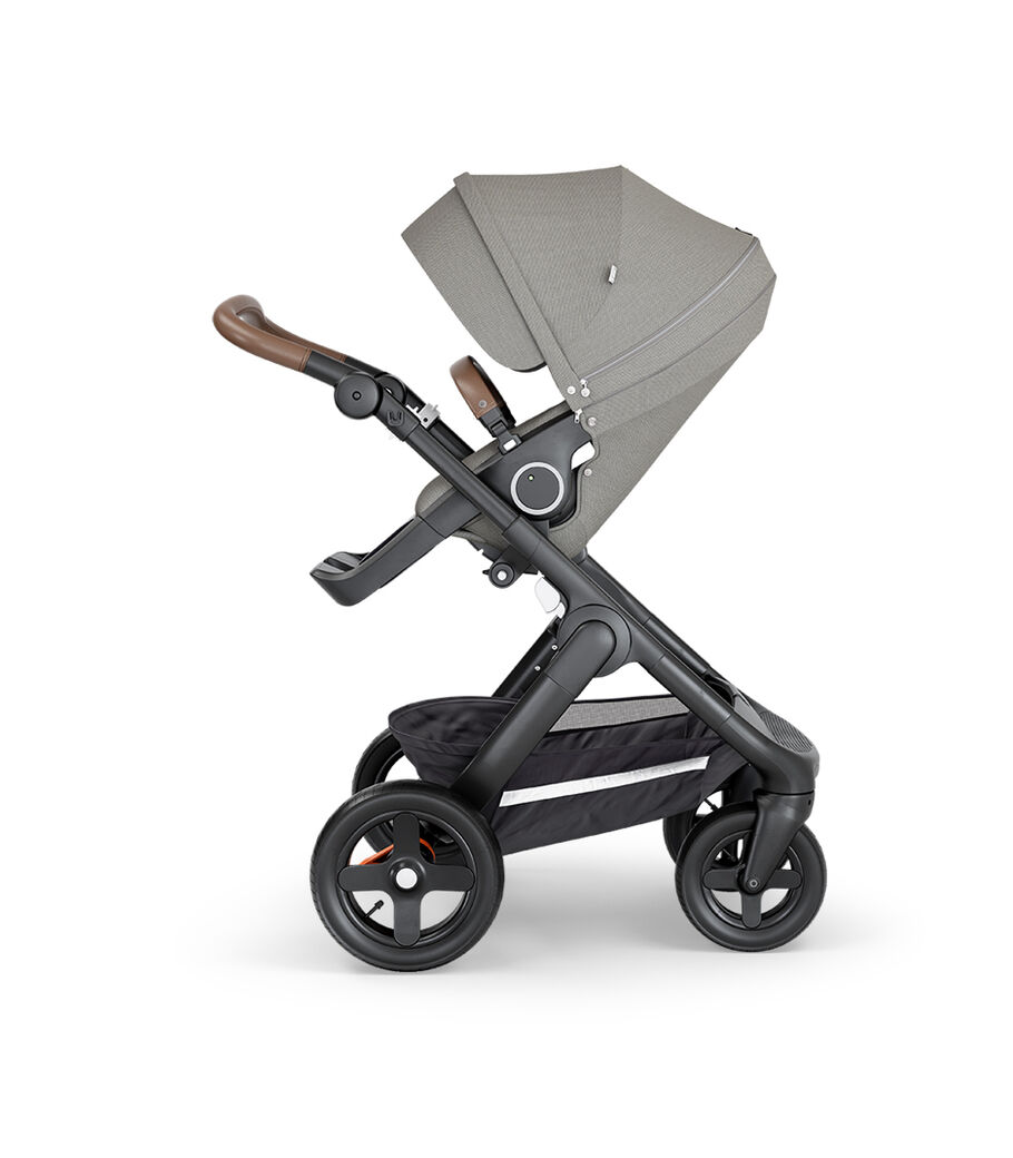 Stokke&reg; Trailz&trade; with Black Chassis, Brown Leatherette and Terrain Wheels. Stokke&reg; Stroller Seat, Brushed Grey.
