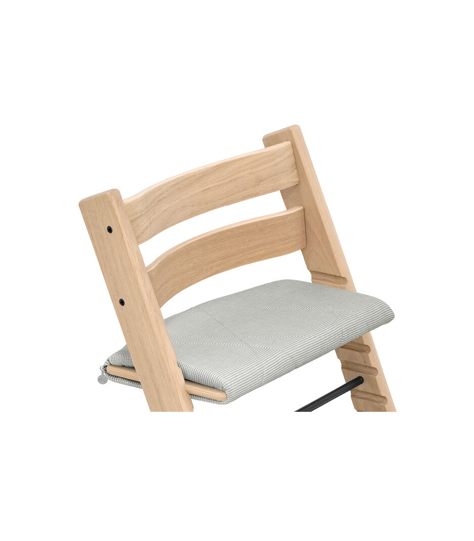 Tripp Trapp® chair Oak Natural, with Junior Cushion Nordic Grey.