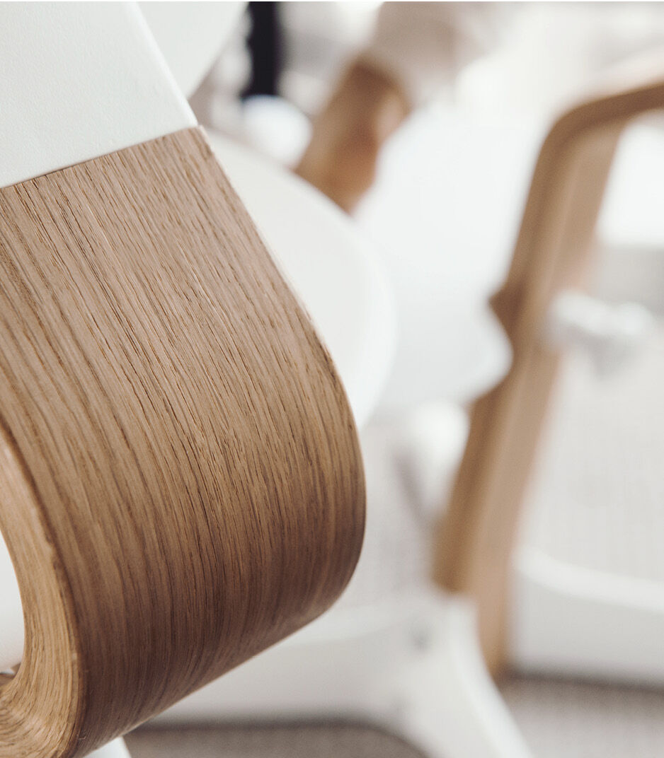 Stokke® Nomi® Chair. Oak premium wood and White plastic parts. Styled/details.