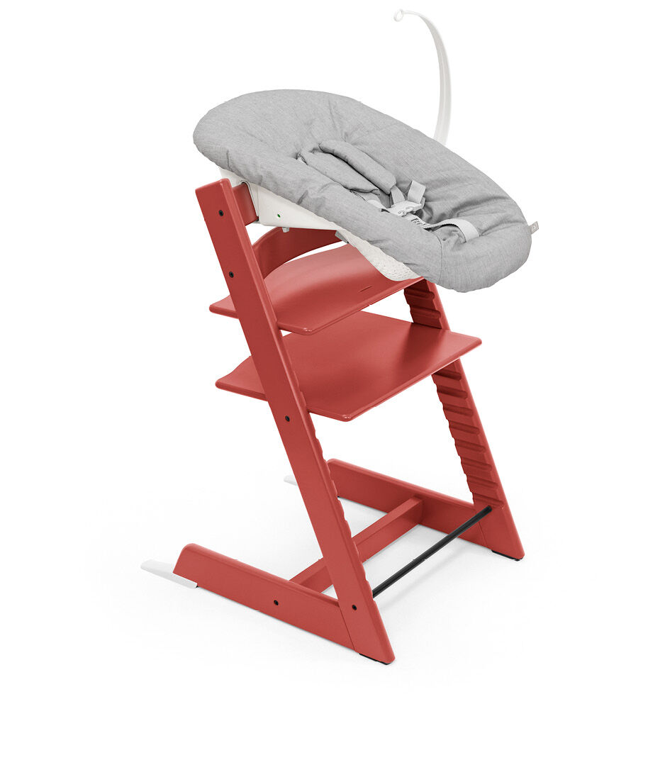 Tripp Trapp® chair Warm Red, Beech Wood, with Newborn Set, Active with Toy Hanger.