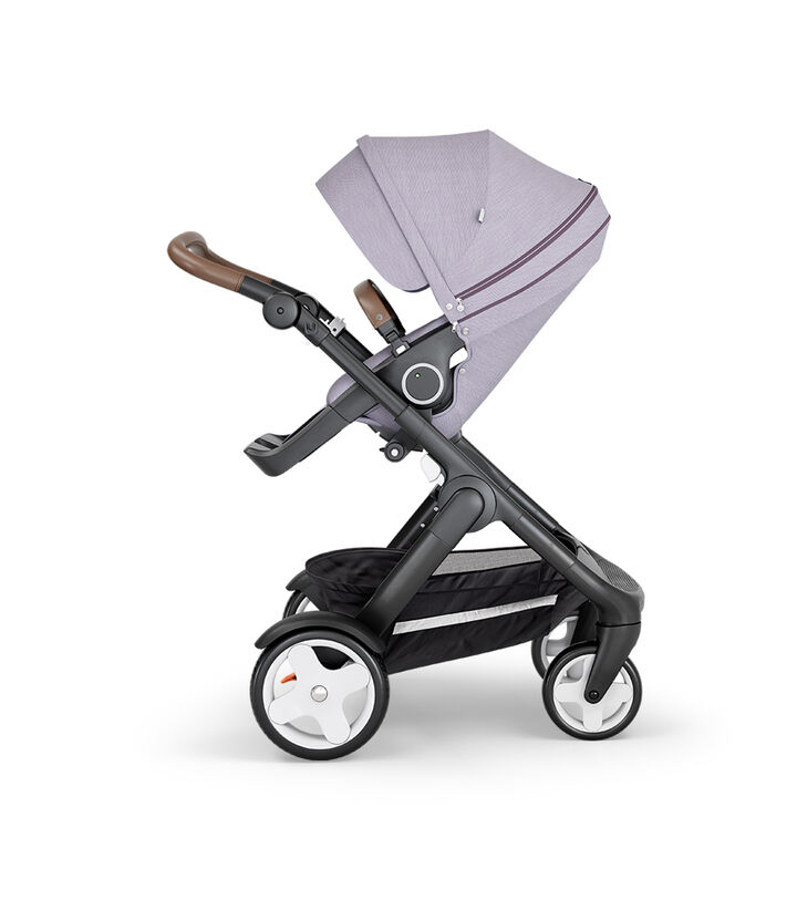 Stokke® Trailz™ with Black Chassis, Brown Leatherette and Classic Wheels. Stokke® Stroller Seat, Brushed Lilac. view 1
