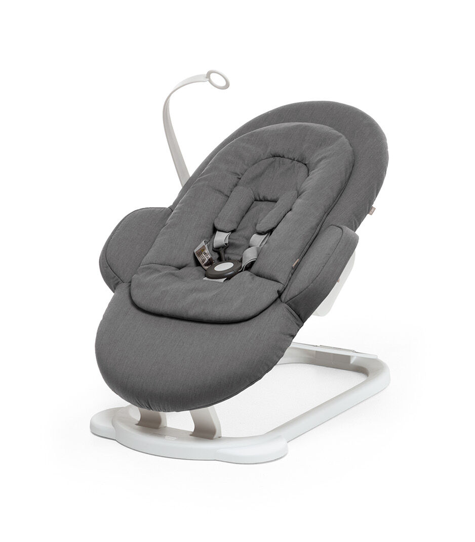 Stokke® Steps Bouncer in Deep Grey with White Base and Toy Hanger.