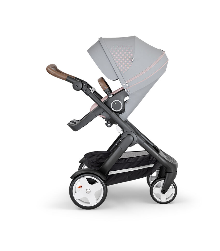 Stokke&reg; Trailz&trade; with Black Chassis, Brown Leatherette and Classic Wheels. Stokke&reg; Stroller Seat, Athleisure Pink.
