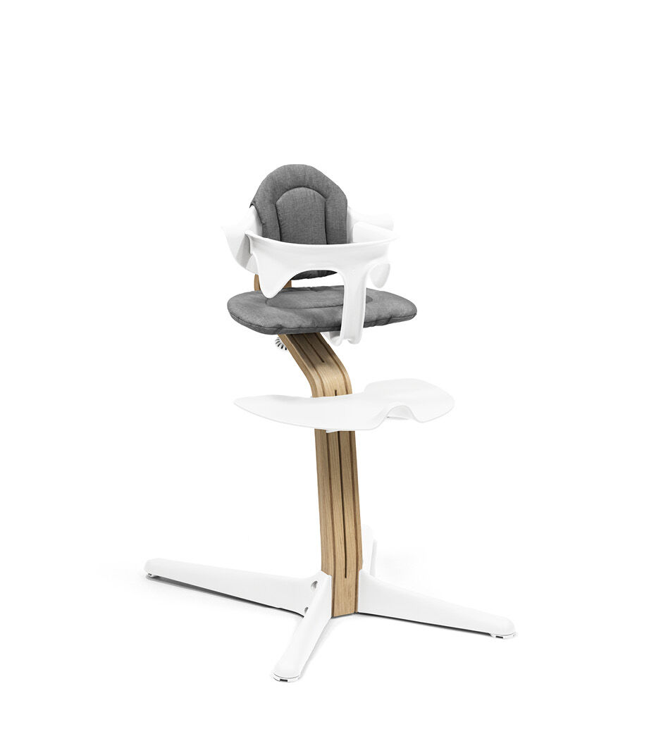 Stokke® Nomi® Chair. Premium Oak wood and White plastic parts. With Baby Set White and Cushion Grey.