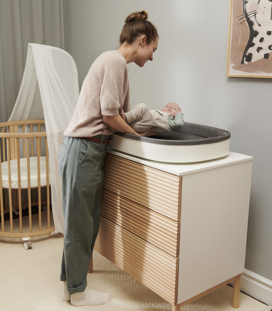 Stokke® Sleepi™ Mini V3 with Canopy and Stokke® Sleepi™ Dresser with Stokke® Sleepi™ Changer.