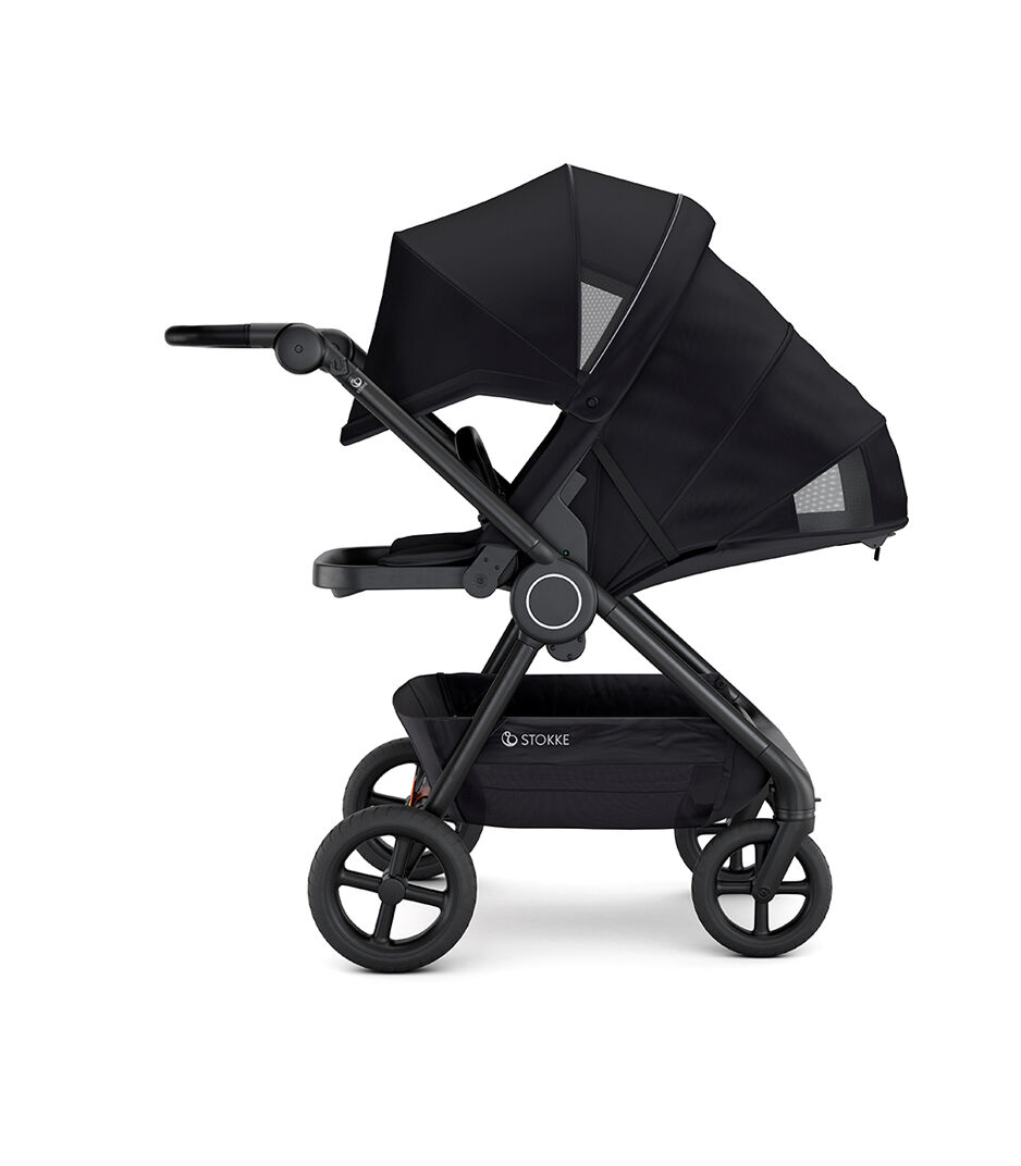 Stokke® Beat™ with Seat. Black. Parent facing. Extended Canopy. Sleep position.
