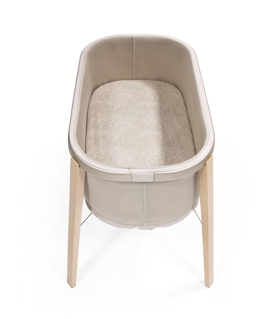 Stokke® Snoozi™ Sandy Beige with Fitted Sheet Dandelion Beige. Top view.
