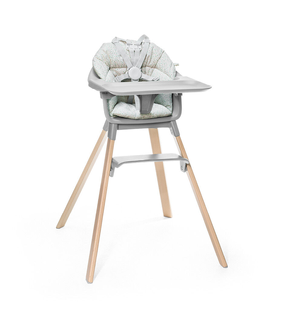 Stokke® Clikk™ High Chair. Natural Beech wood and Cloud Grey plastic parts including Tray. Cushion Grey Sprinkle and Harness.