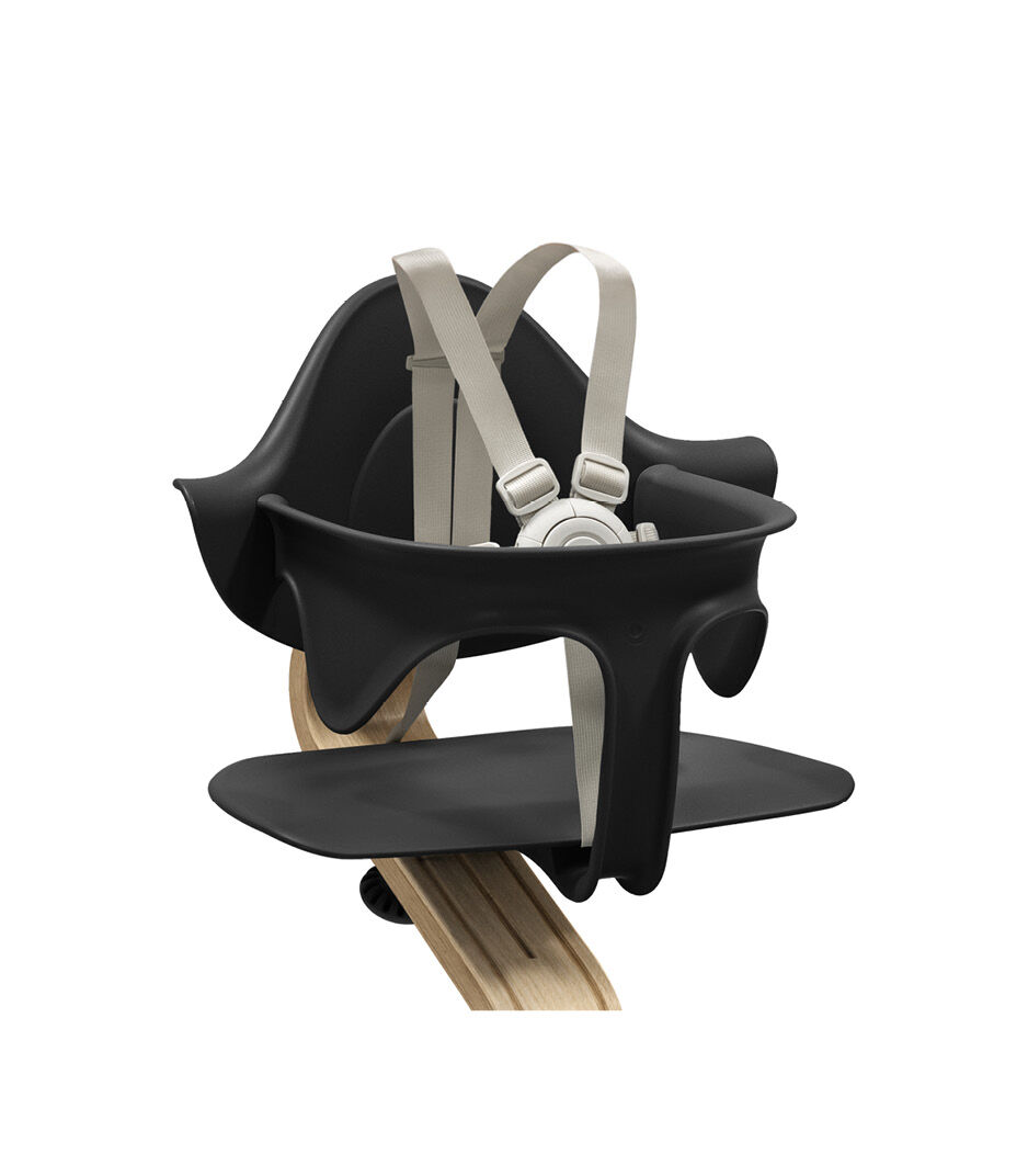 Stokke® Nomi® Chair. Premium Oak wood and Black plastic parts. With Baby Set Black. US variant w/Harness. Close-up. galery image 1