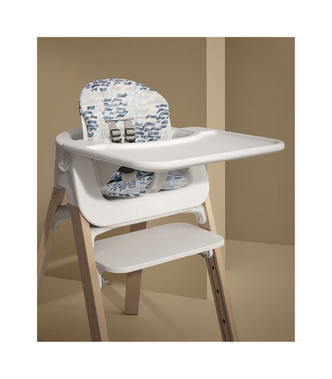 Stokke® Steps™ Natural with Baby Set Tray and Cushion Waves Blue. Styled. view 2