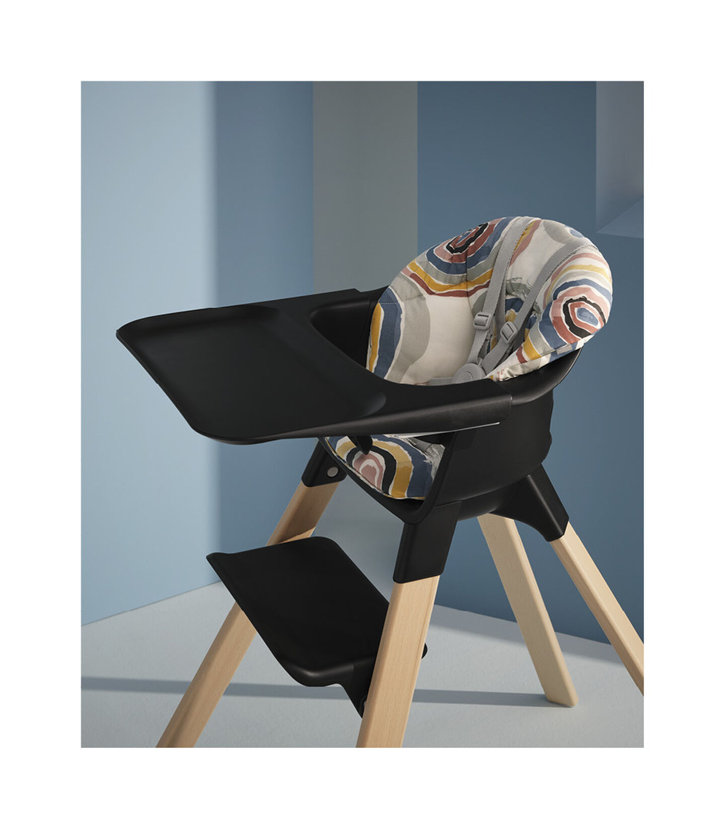 Stokke® Clikk™ High Chair Black with Natural Beech legs, and Multi Circle cushion. Styled. view 2