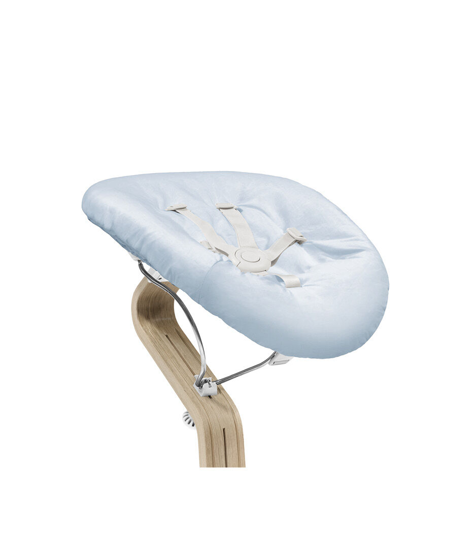 Stokke® Nomi® Chair Natural-White with Newborn Set Blue. Close-up.
