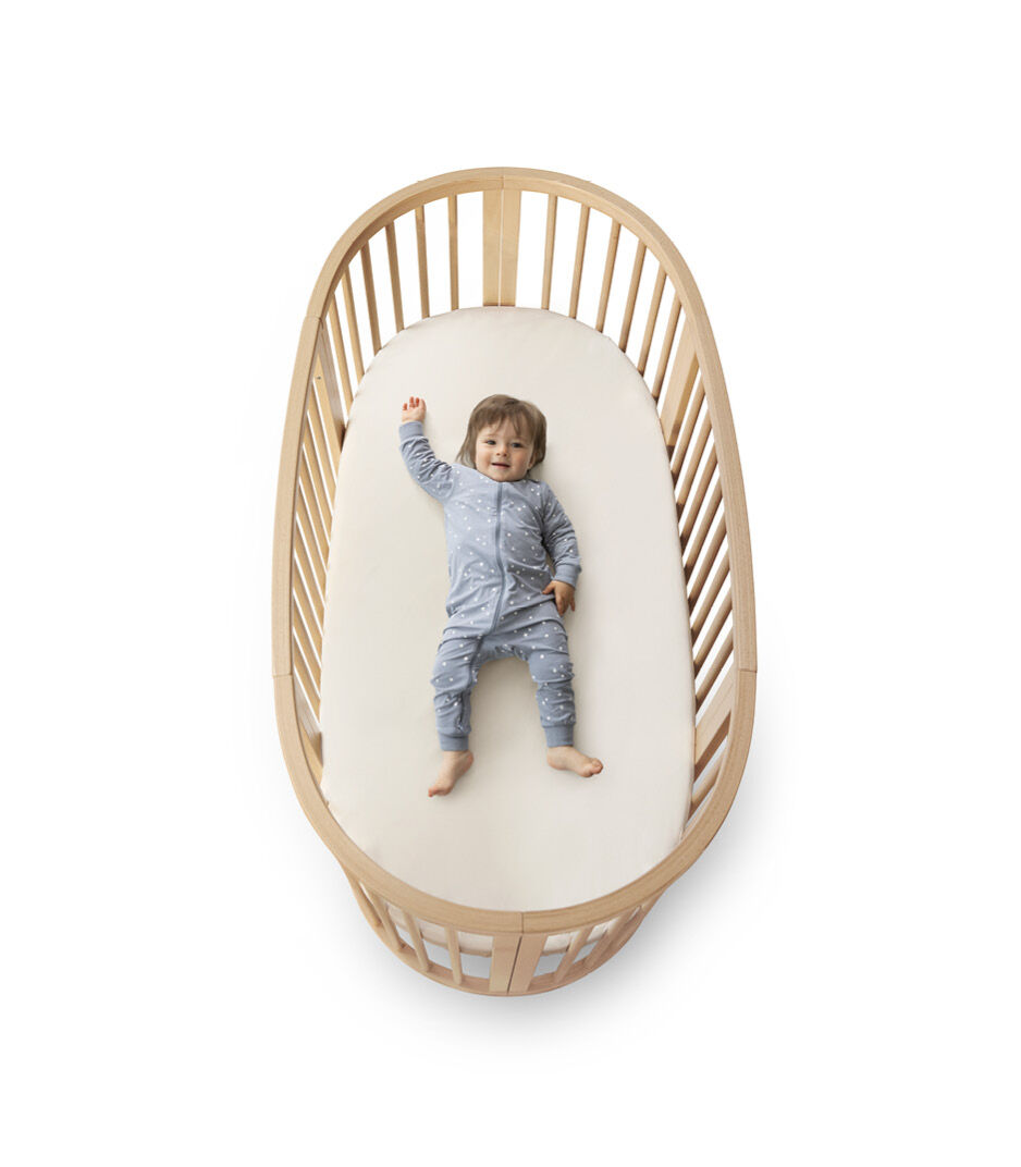 Stokke® Sleepi™ Bed V3 Natural. Closed, with mattress. Isolated.
