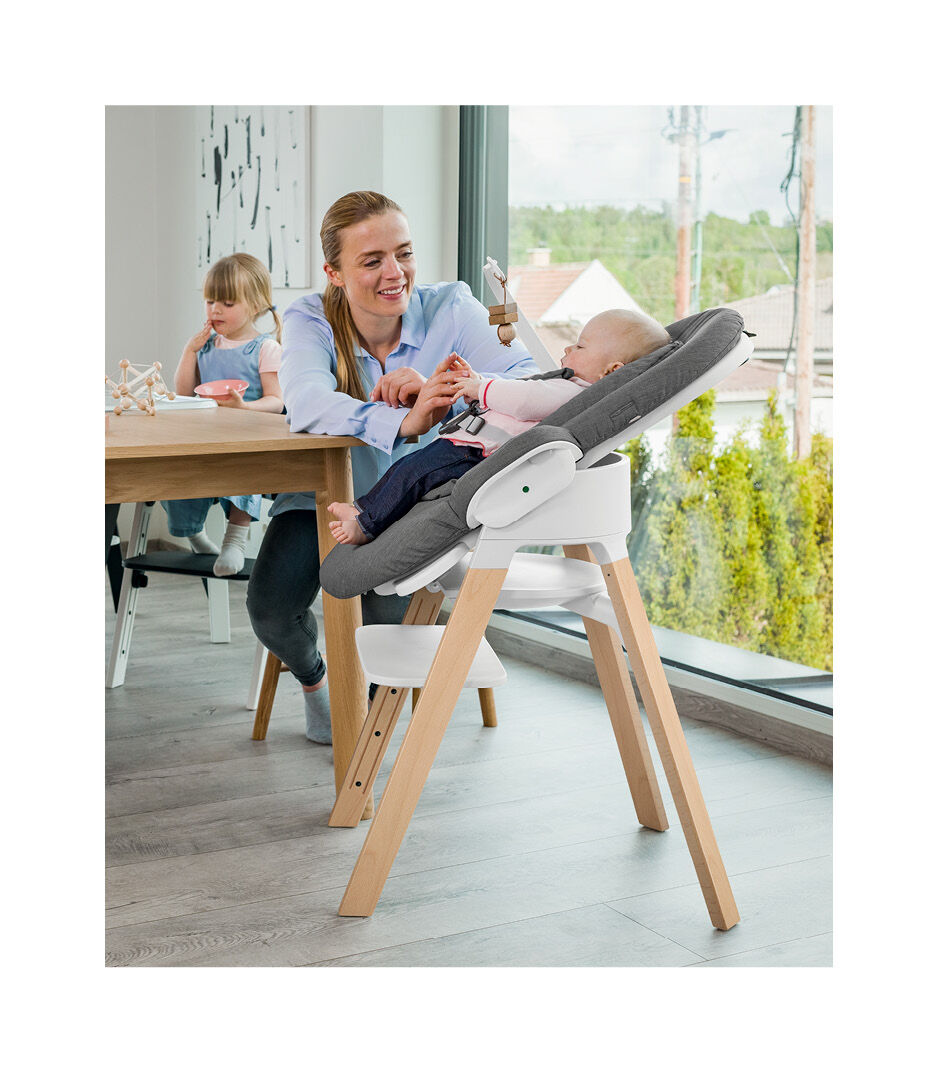 Stokke® Steps™ high chair. Beech Natural with White seat. Bouncer Deep Grey.