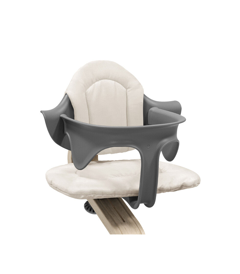 Stokke® Nomi® Chair Natural-Grey with Baby Set and Cushion, Sand. Close-up.