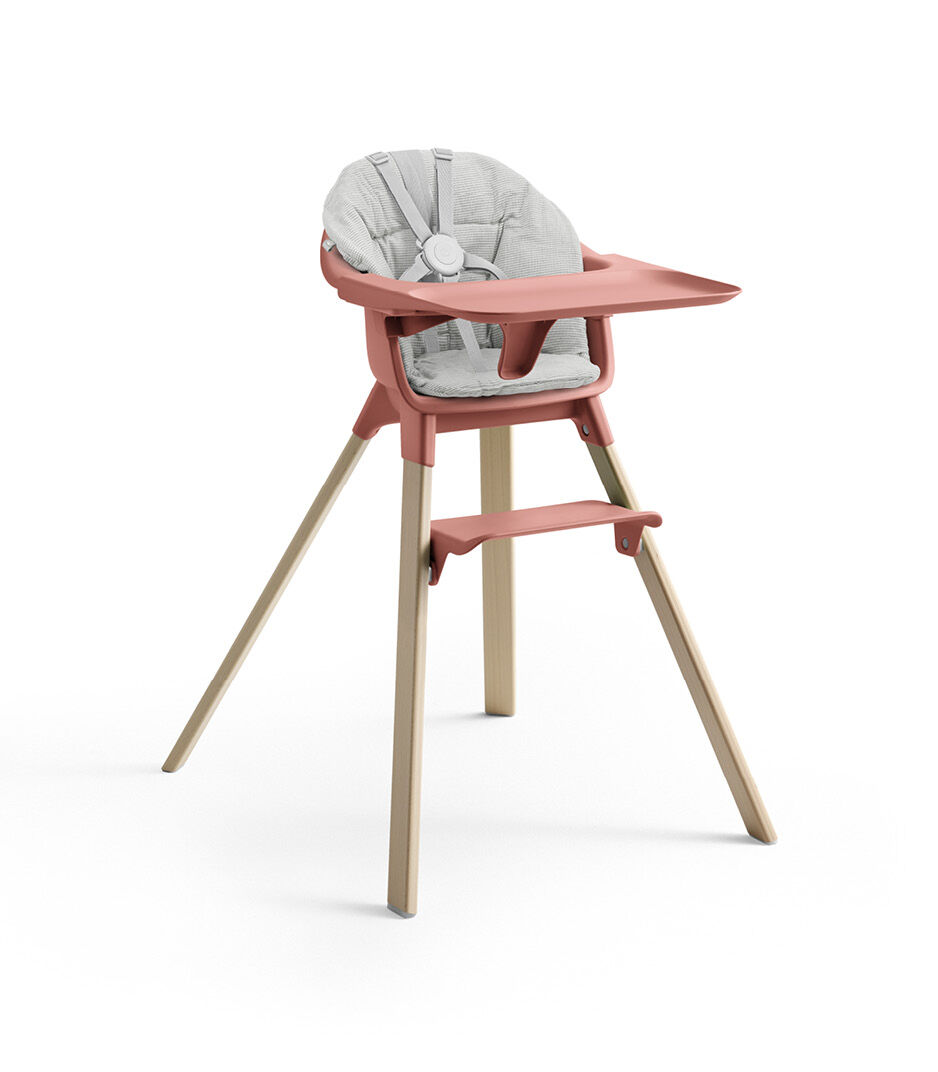 Stokke® Clikk™ High Chair with Tray and Harness, in Natural and Sunny Coral. Cushion Nordic Grey.