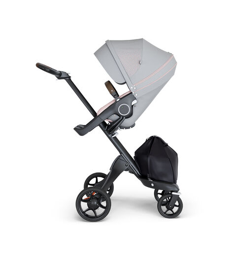 Stokke® Xplory® wtih Black Chassis and Leatherette Brown handle. Stokke® Stroller Seat Athleisure Pink. view 2