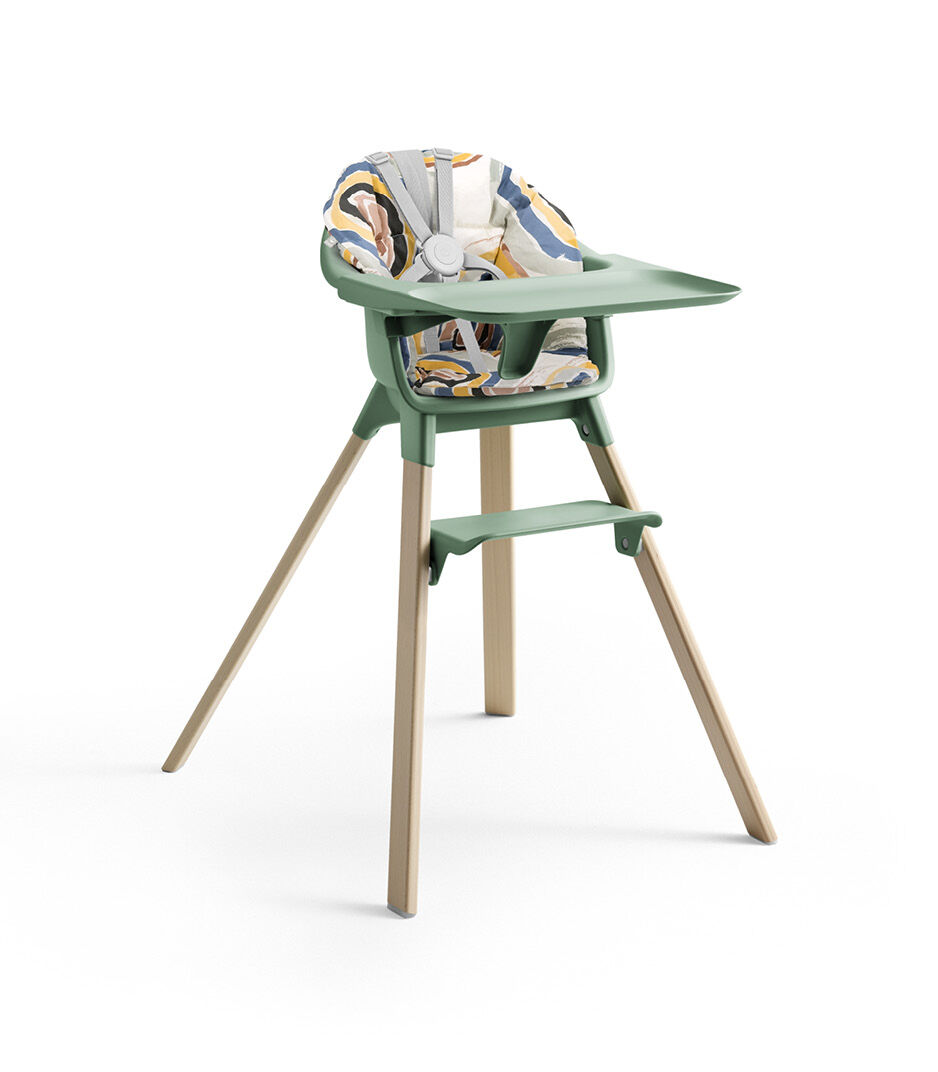 Stokke® Clikk™ High Chair with Tray and Harness, in Natural and Clover Green. Cushion Multi Circle.