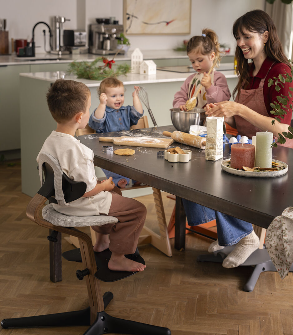 Tripp Trapp® Natural with Baby Set and Storage. Stokke® Nomi® Walnut/Black with Nordic Grey cushion.