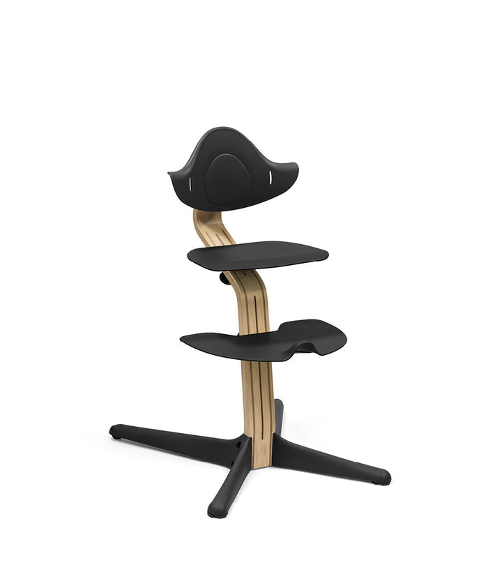 Stokke® Nomi® Chair. Premium Oak wood and Black plastic parts.  view 1