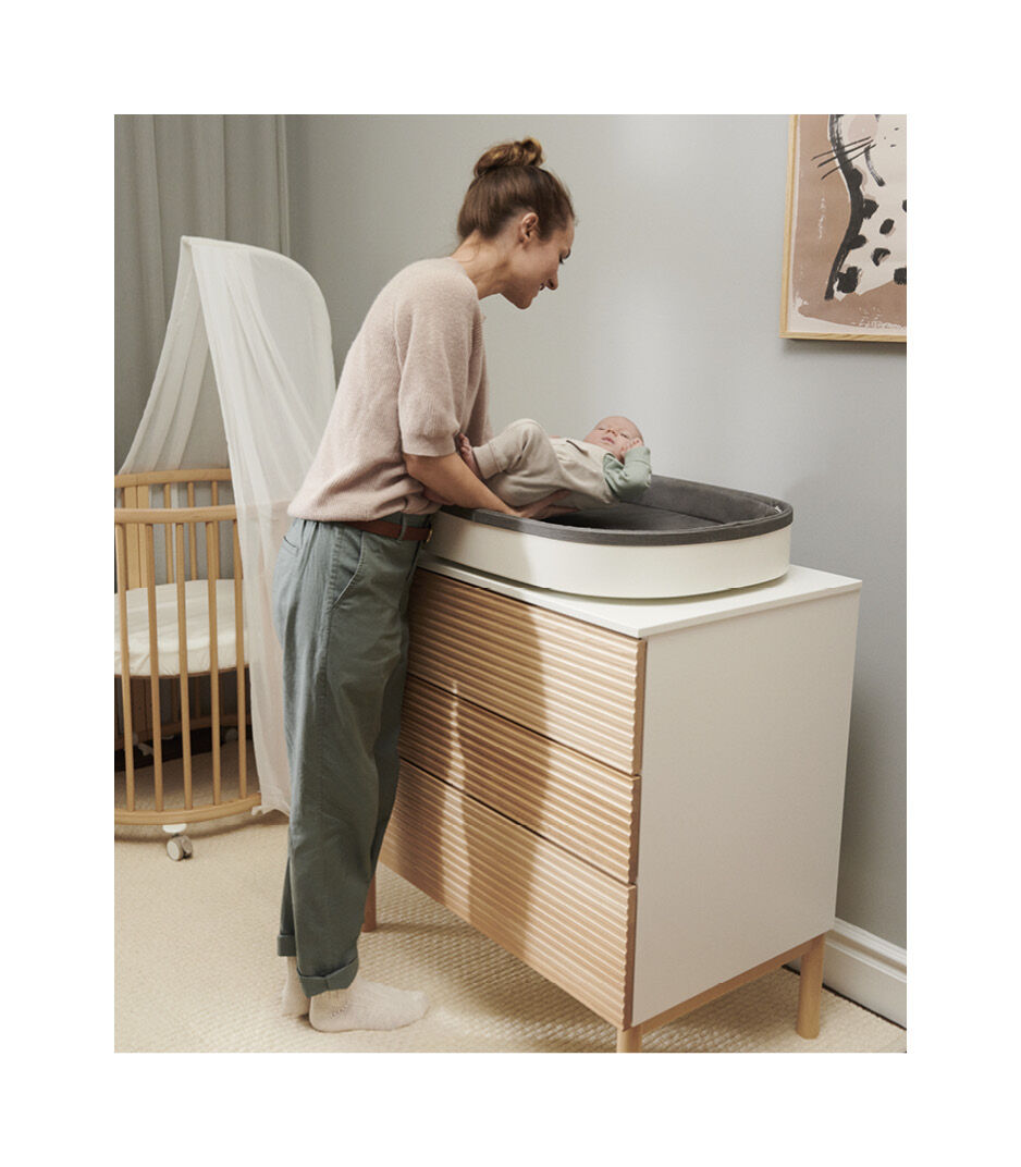 Stokke® Sleepi™ Mini V3 with Canopy and Stokke® Sleepi™ Dresser with Stokke® Sleepi™ Changer.