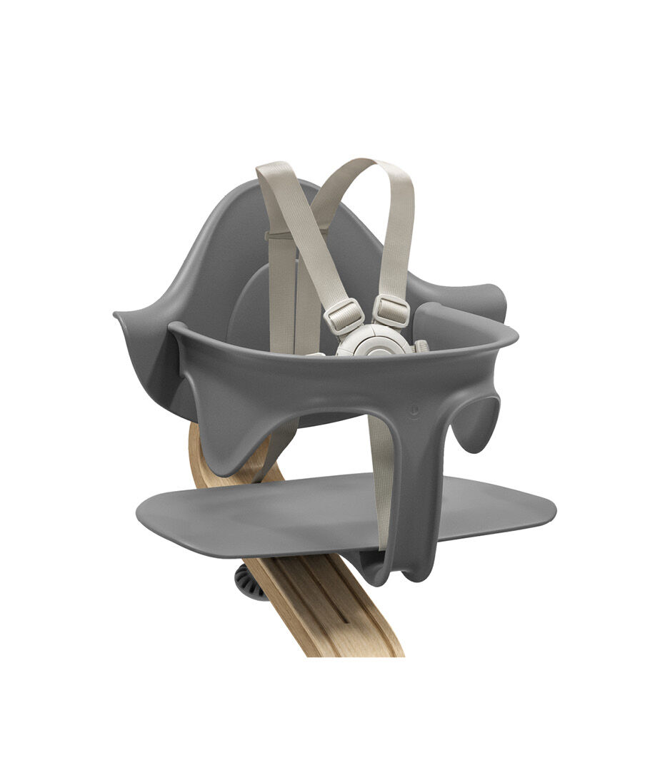 Stokke® Nomi® Chair. Premium Oak wood and Grey plastic parts. With Baby Set Grey. US variant w/Harness. Close-up.