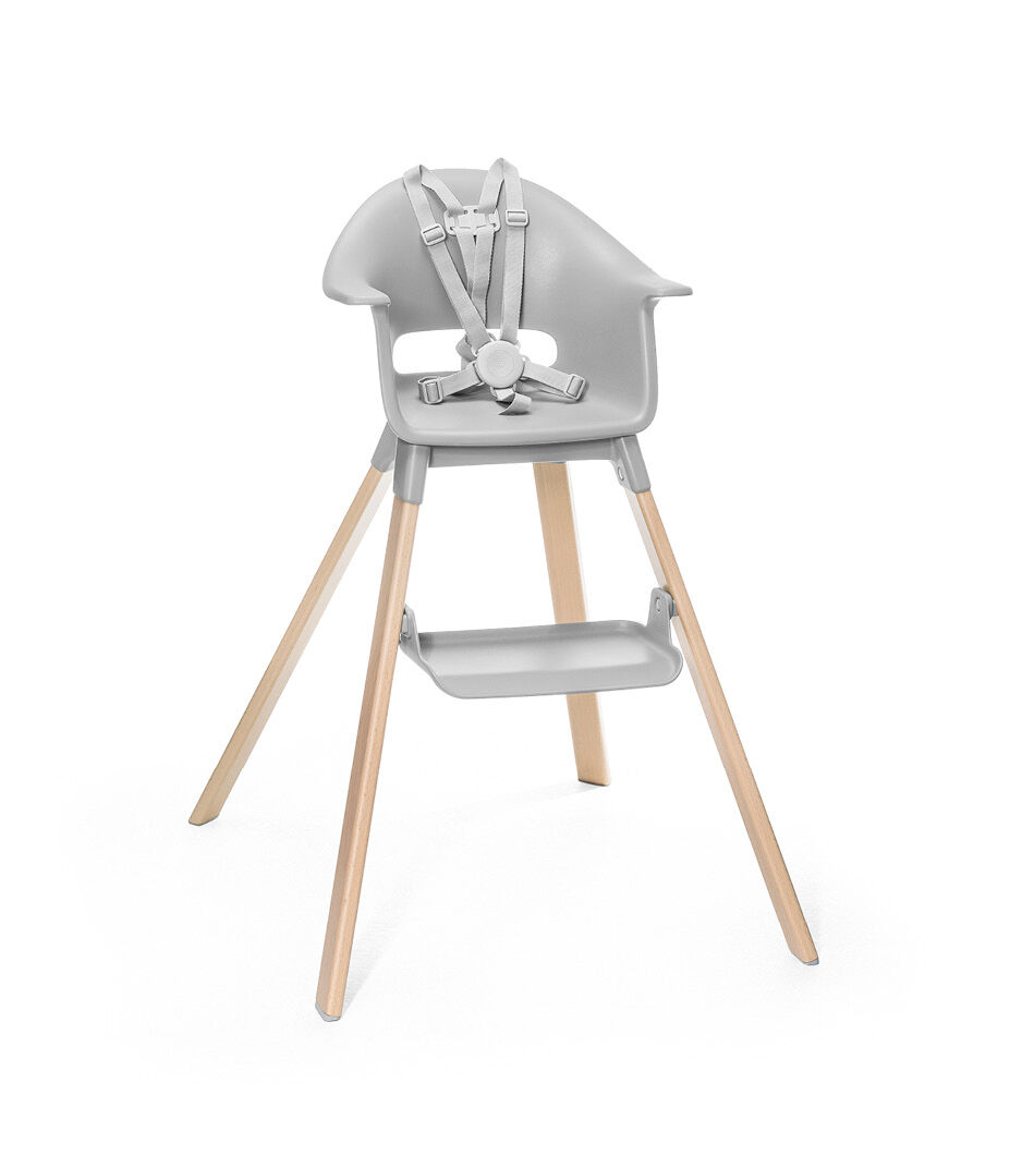 Stokke® Clikk™ High Chair. Natural Beech wood and Light Grey plastic parts. Stokke® Harness attached. Footrest high.