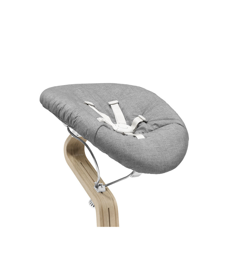 Stokke® Nomi® Chair Natural-White with Newborn Set Grey. Close-up.