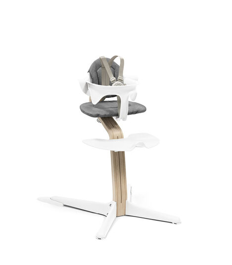Stokke® Nomi® Chair. Premium Oak wood and White plastic parts. With Baby Set White and Cushion Grey. US variant w/Harness. view 4