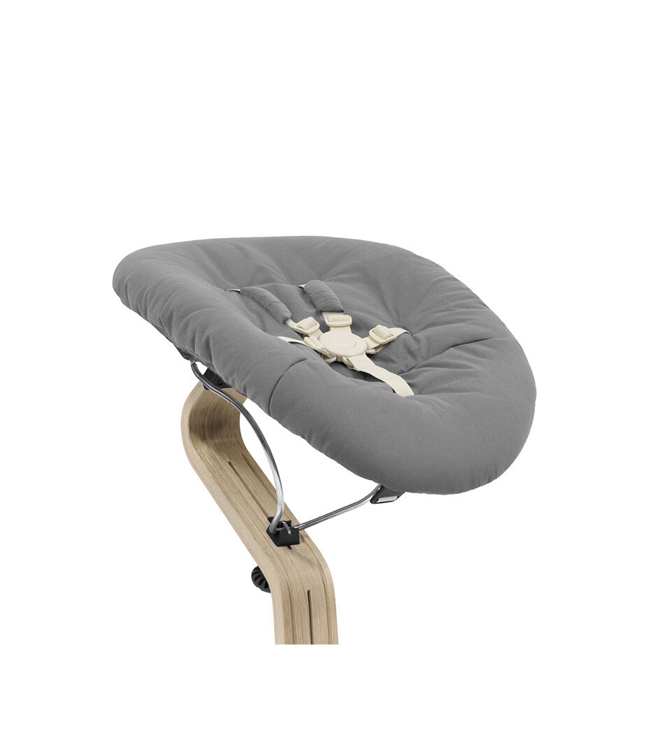 Stokke® Nomi® Chair Natural-Black with Newborn Set Grey. Close-up.
