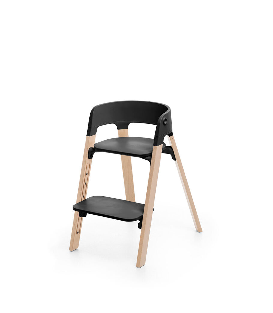 Stokke® Steps™ Chair, Beech Natural with Black Seat. Footrest low. view 1