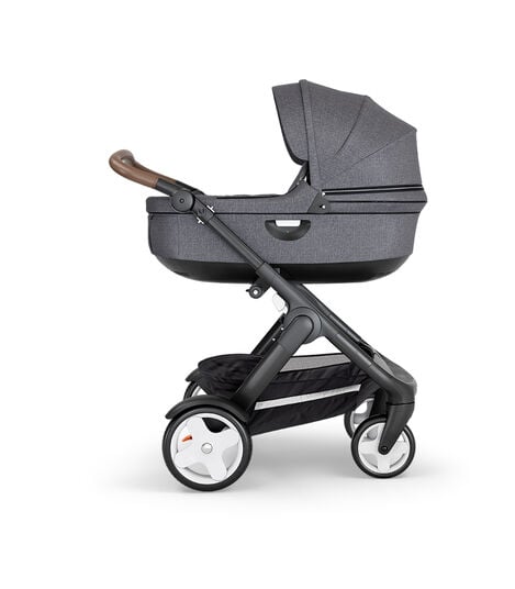 Stokke® Trailz™ with Black Chassis, Brown Leatherette and Classic Wheels. Stokke® Stroller Carry Cot, Black Melange. view 2